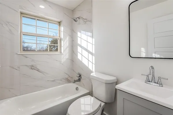 a bathroom with a sink toilet and bathtub