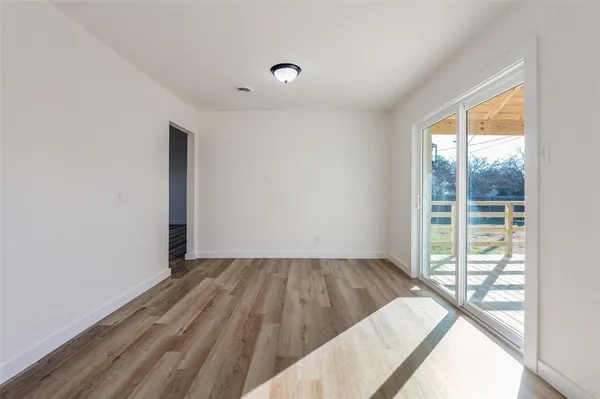a view of a room with wooden floor and iron gate