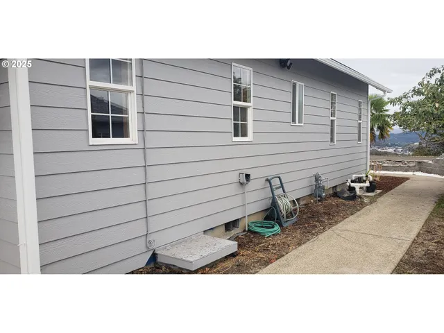 a side view of a house with backyard