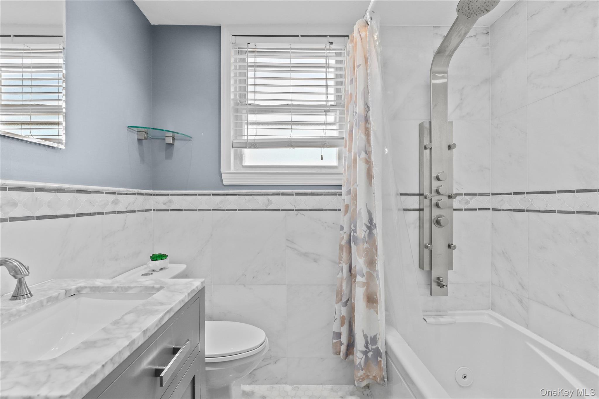 69 Clinton Avenue New Rochelle, NY 10801 - Photo 12 of 29 a bathroom with a sink toilet and shower