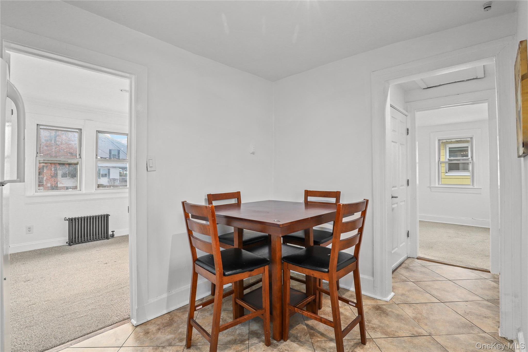 69 Clinton Avenue New Rochelle, NY 10801 - Photo 15 of 29 a view of a dining room with furniture and window