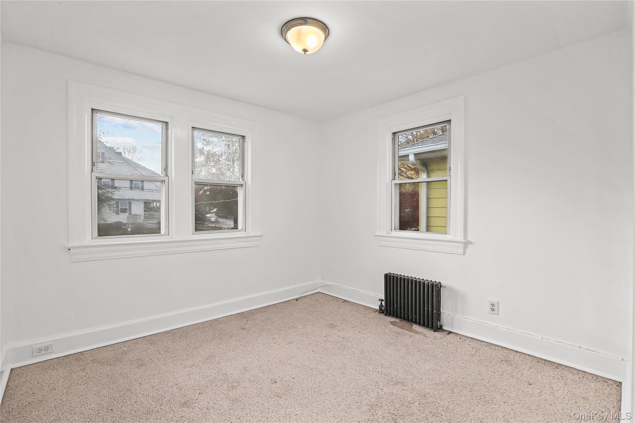 69 Clinton Avenue New Rochelle, NY 10801 - Photo 18 of 29 an empty room with windows