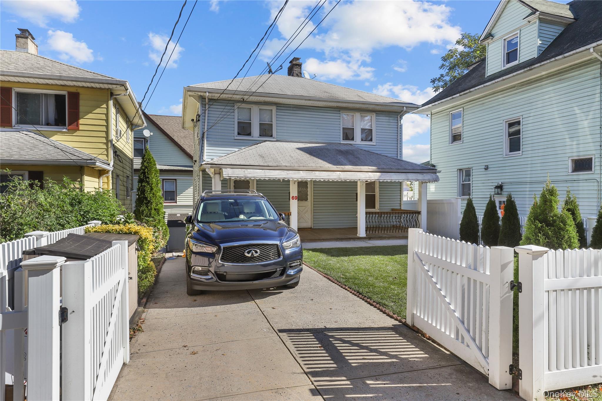 69 Clinton Avenue New Rochelle, NY 10801 - Photo 2 of 29 a front view of a house with a yard