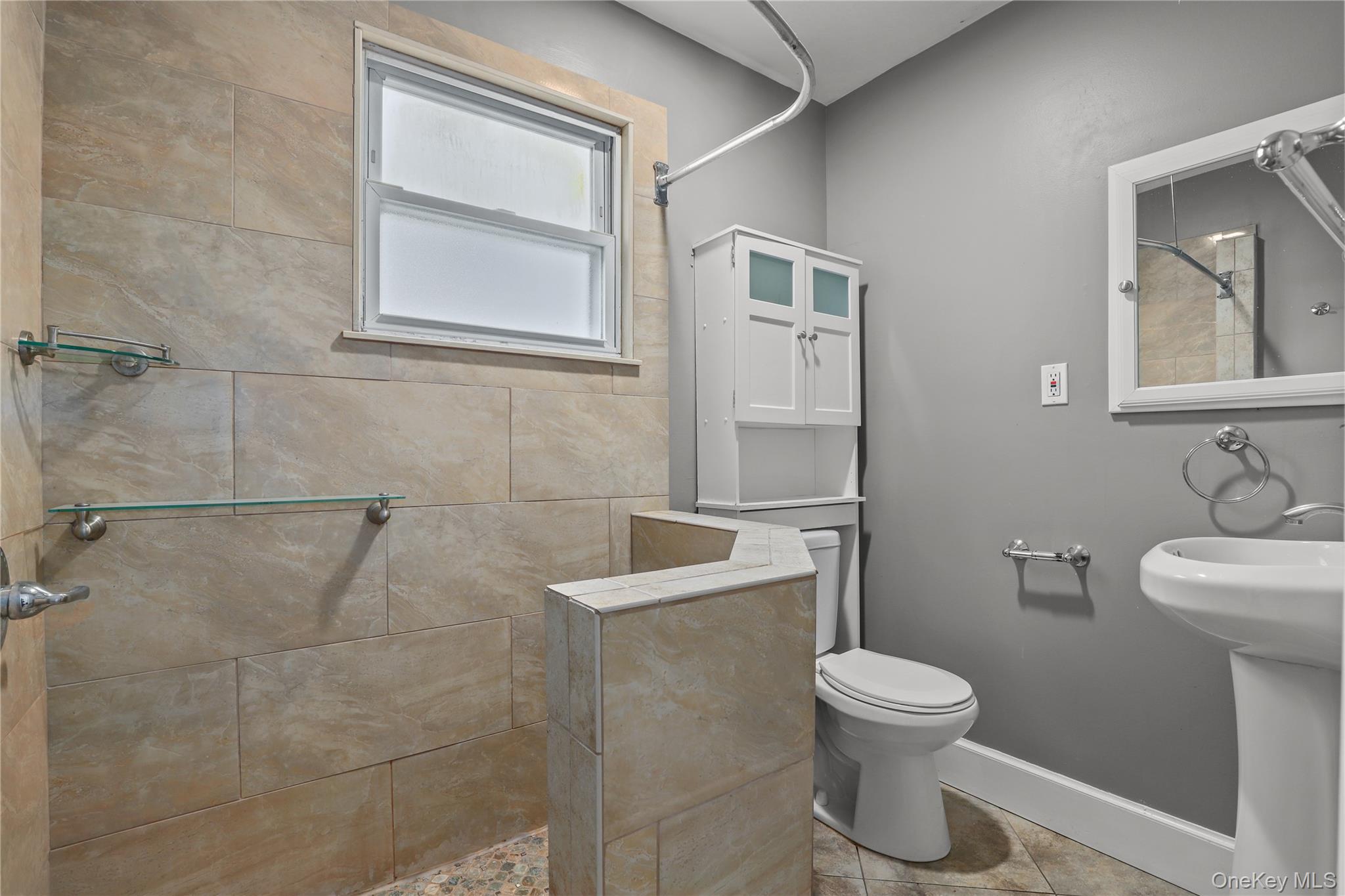 69 Clinton Avenue New Rochelle, NY 10801 - Photo 21 of 29 a white toilet sitting next to a bathroom sink