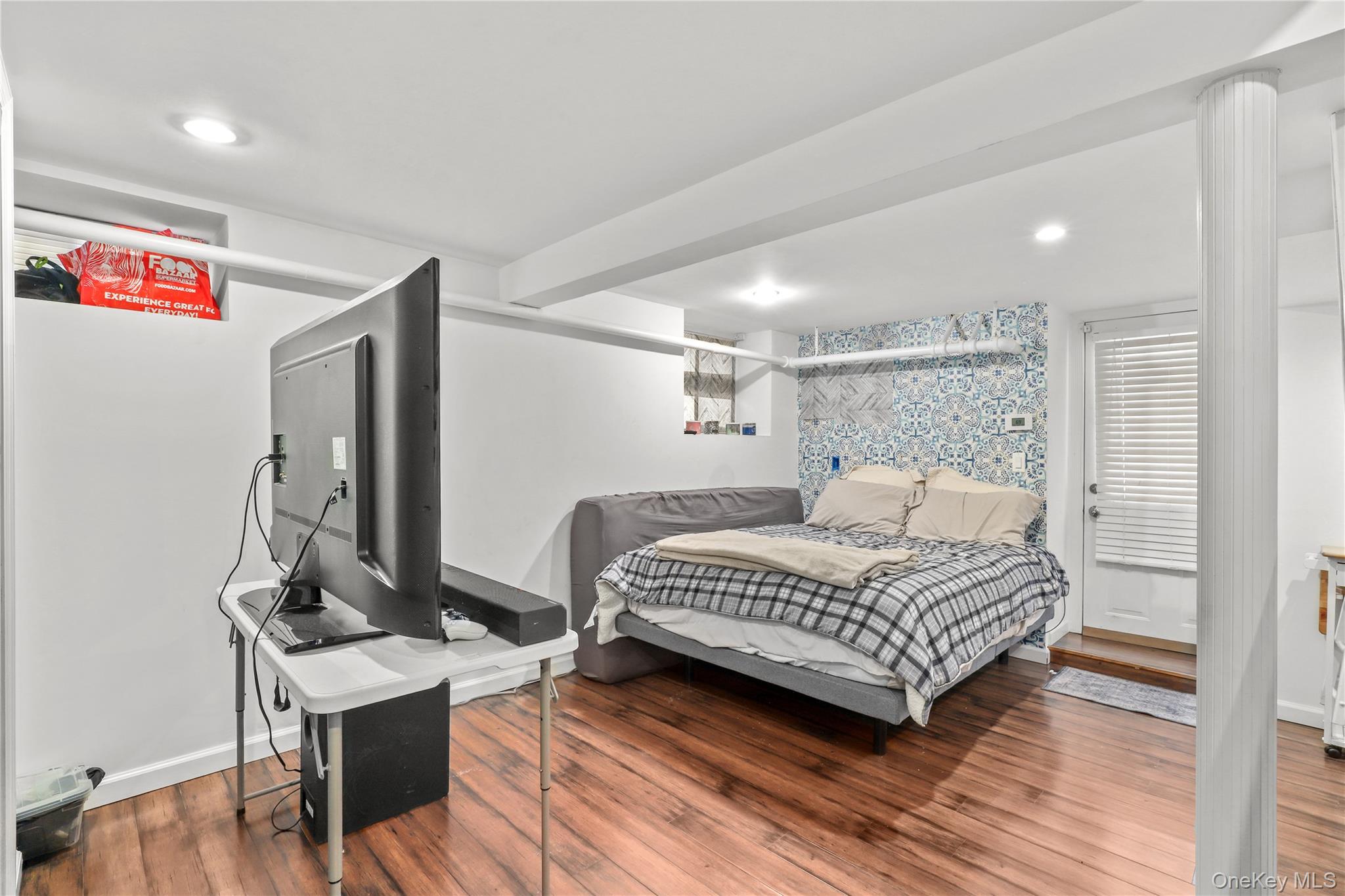 69 Clinton Avenue New Rochelle, NY 10801 - Photo 23 of 29 a bedroom with a bed and a table in it