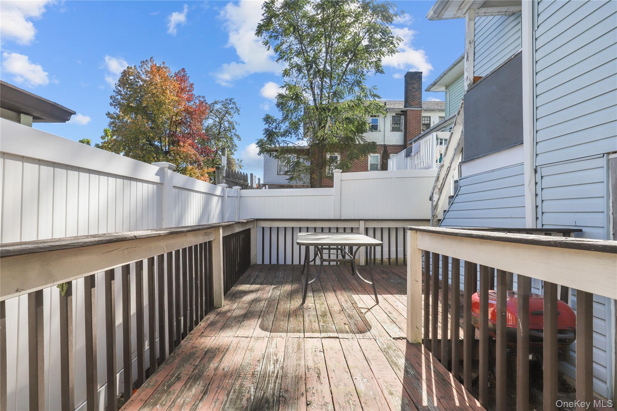 69 Clinton Avenue New Rochelle, NY 10801 - Photo 28 of 29 a view of balcony with wooden floor and fence