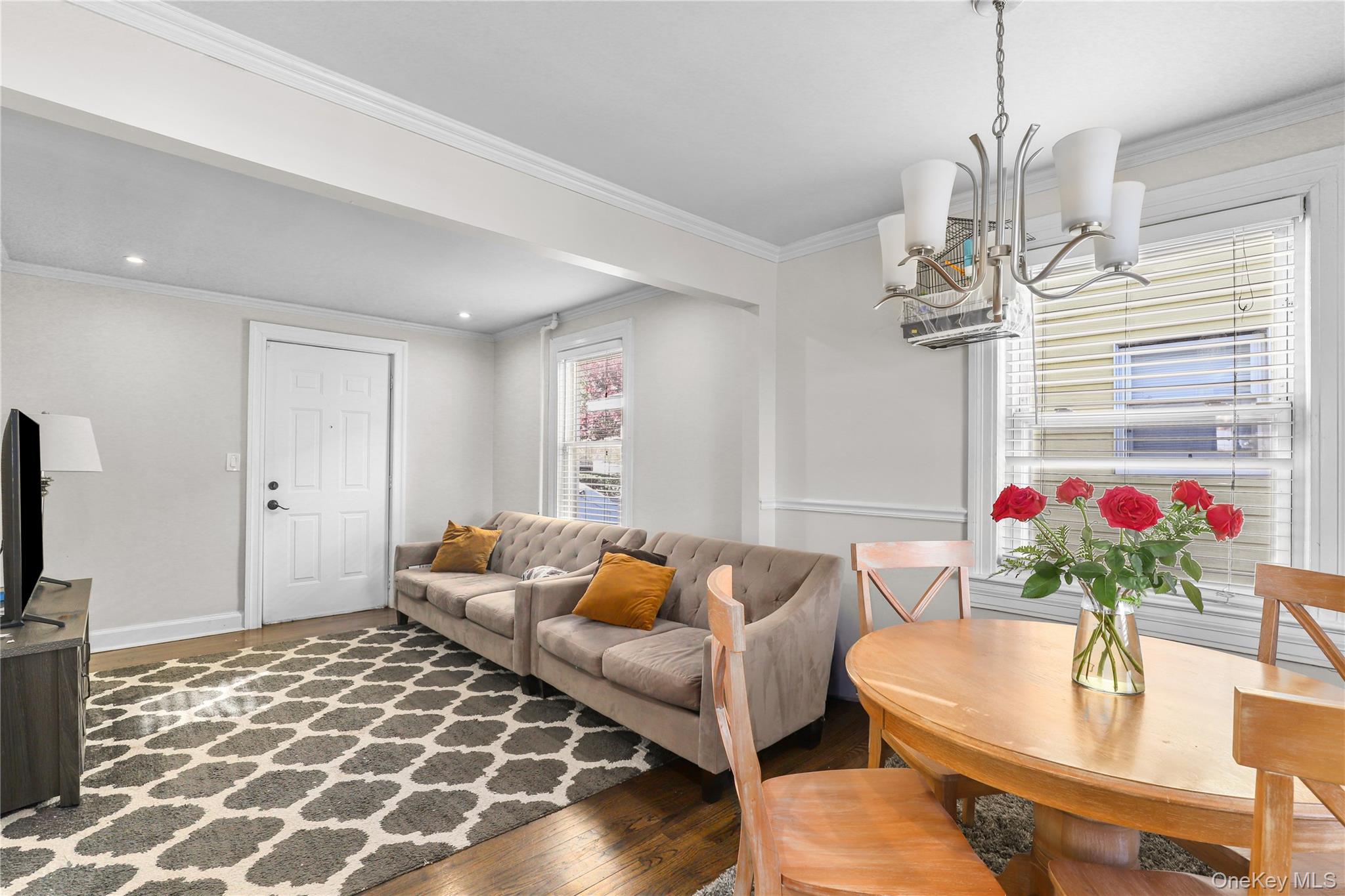 69 Clinton Avenue New Rochelle, NY 10801 - Photo 4 of 29 a living room with furniture and a chandelier