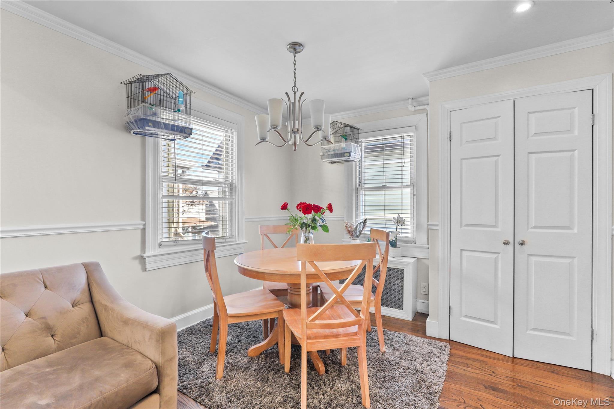 69 Clinton Avenue New Rochelle, NY 10801 - Photo 5 of 29 a dining room with furniture a chandelier and wooden floor