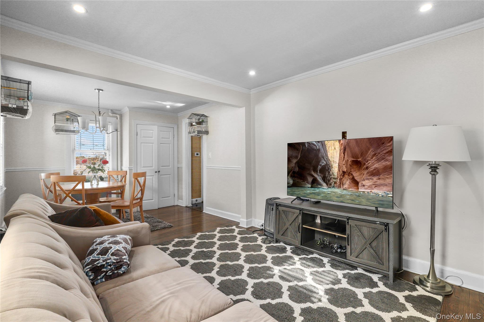 69 Clinton Avenue New Rochelle, NY 10801 - Photo 6 of 29 a living room with furniture and a flat screen tv