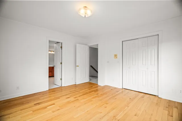 a bathroom with a granite countertop sink a toilet and a mirror