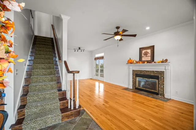 a view of empty room with fan and fireplace