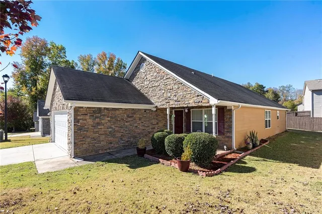 a view of a house with yard and sitting area