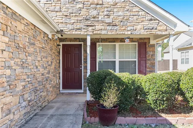 a view of a house with potted plants