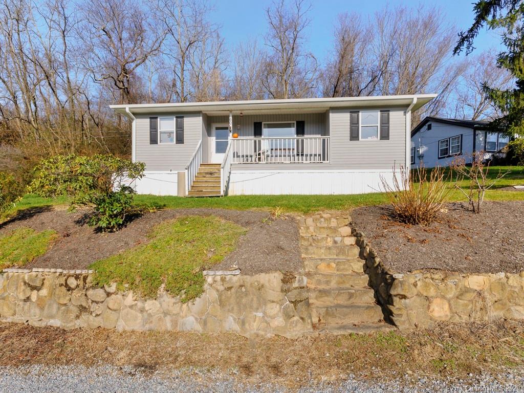 60 Sharptown Road Canton, NC 28716 - Photo 1 of 12 a front view of a house with garden