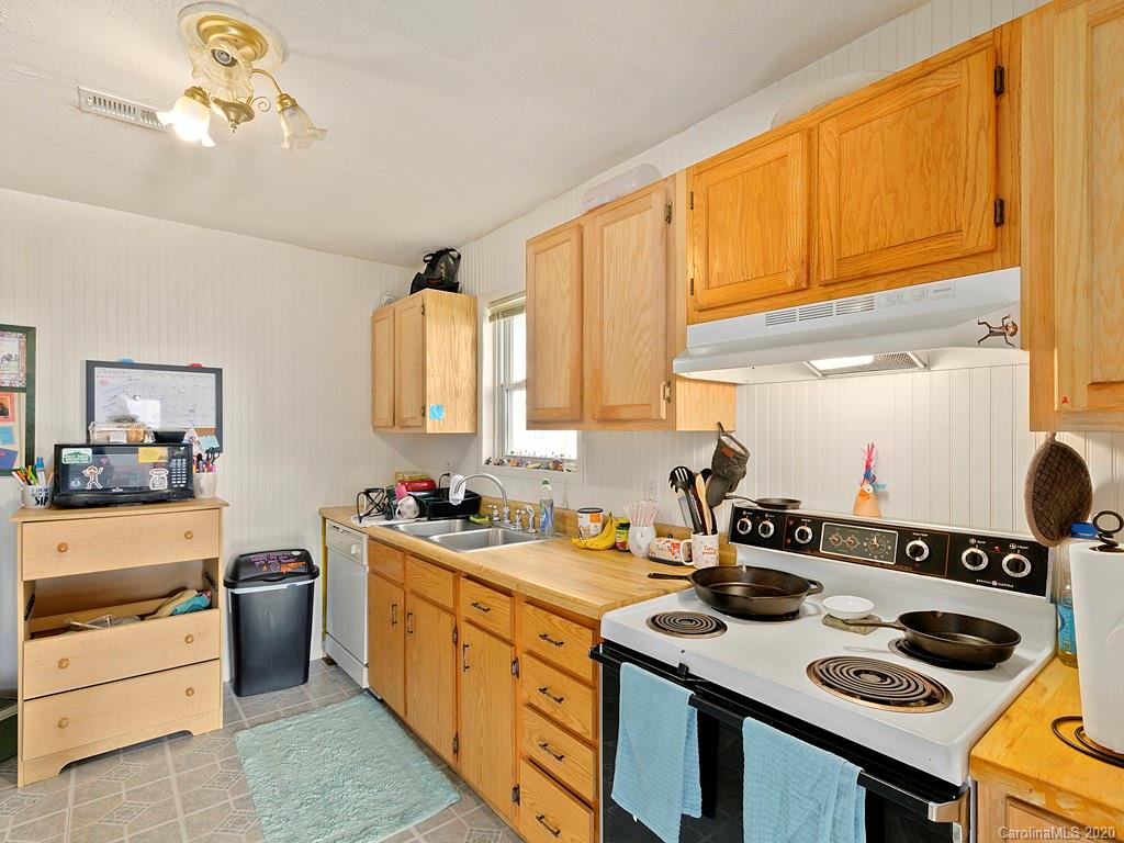 60 Sharptown Road Canton, NC 28716 - Photo 3 of 12 a kitchen with a sink stove and cabinets