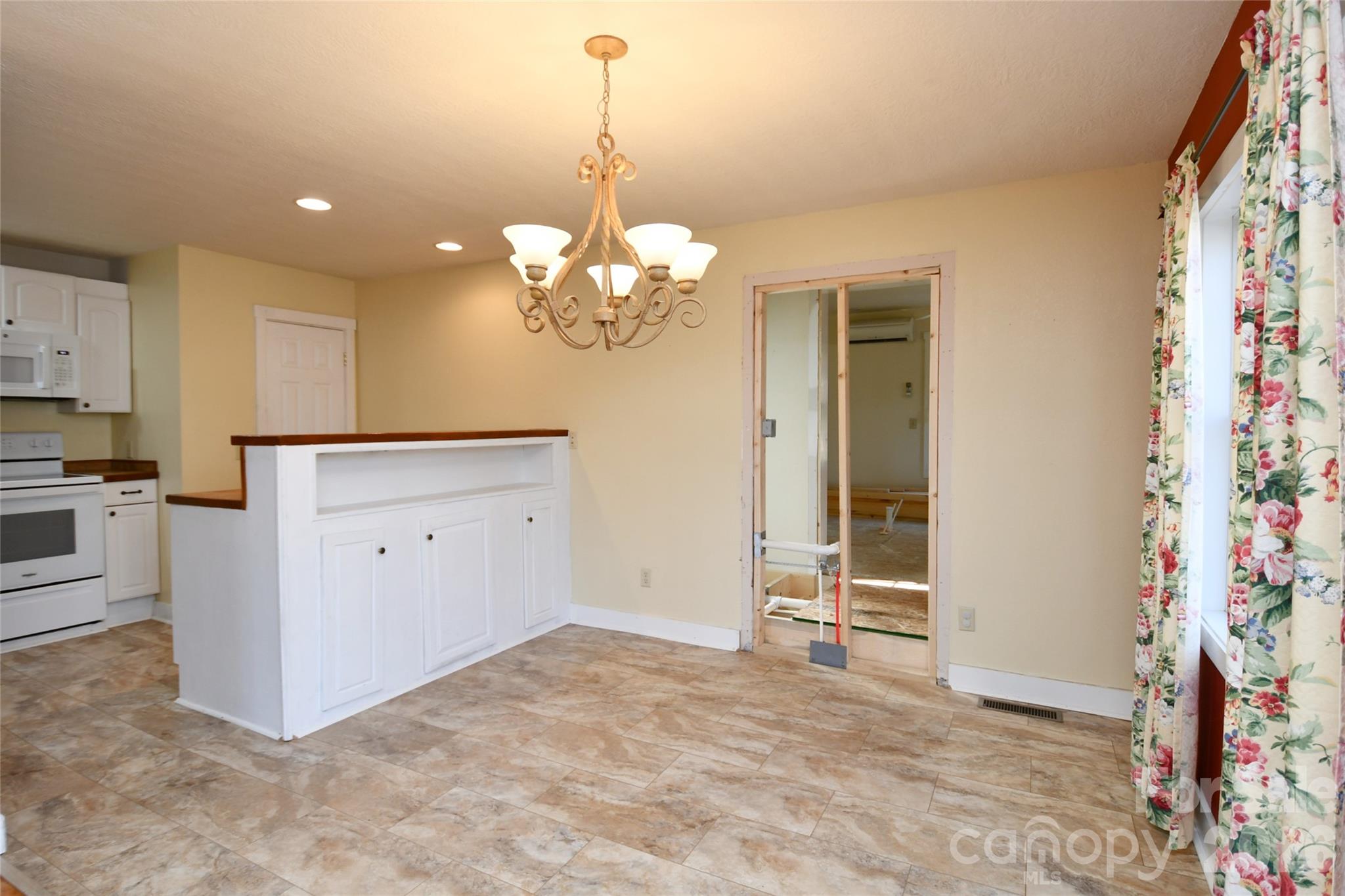 477 West Ridge Drive Burnsville, NC 28714 - Photo 11 of 48 a view of a kitchen with cabinet and refrigerator