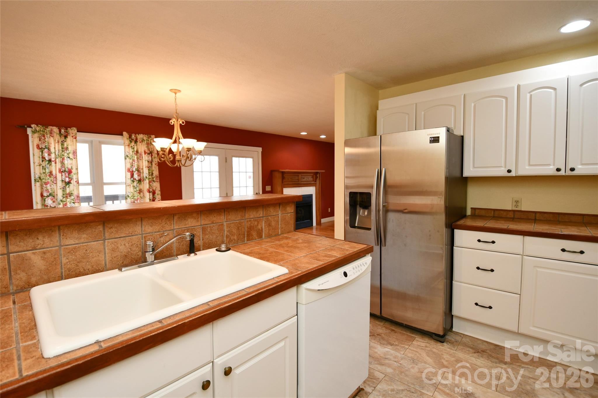477 West Ridge Drive Burnsville, NC 28714 - Photo 14 of 48 a kitchen with a sink refrigerator and cabinets