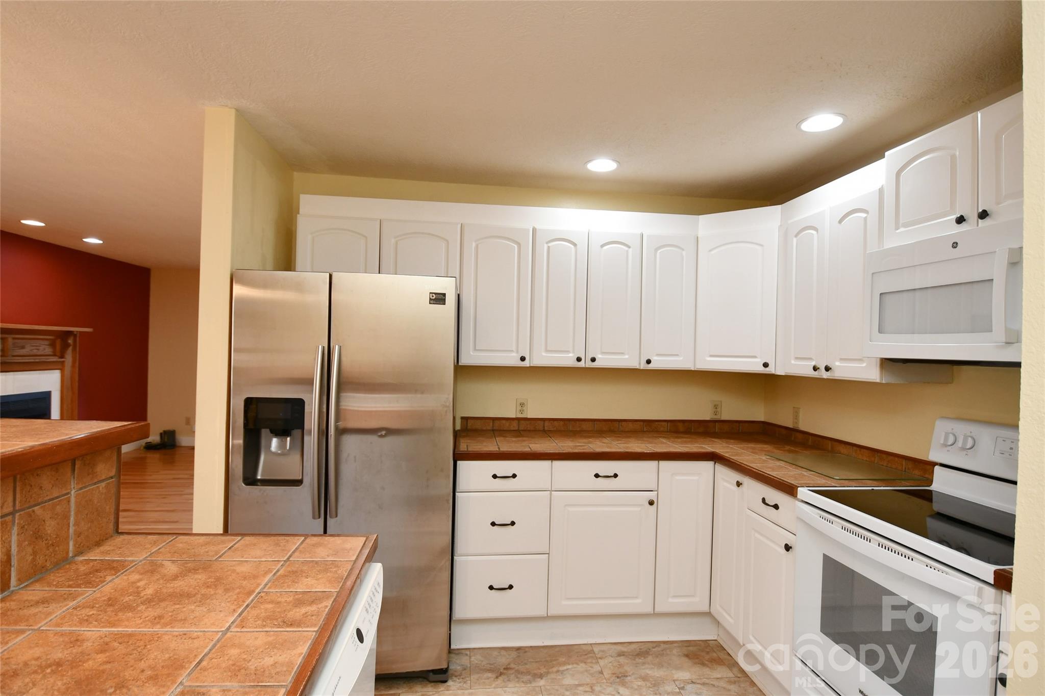 477 West Ridge Drive Burnsville, NC 28714 - Photo 15 of 48 a kitchen with stainless steel appliances a refrigerator sink and cabinets
