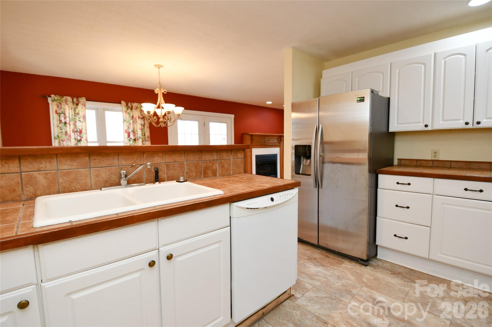 477 West Ridge Drive Burnsville, NC 28714 - Photo 17 of 48 a kitchen with cabinets and stainless steel appliances