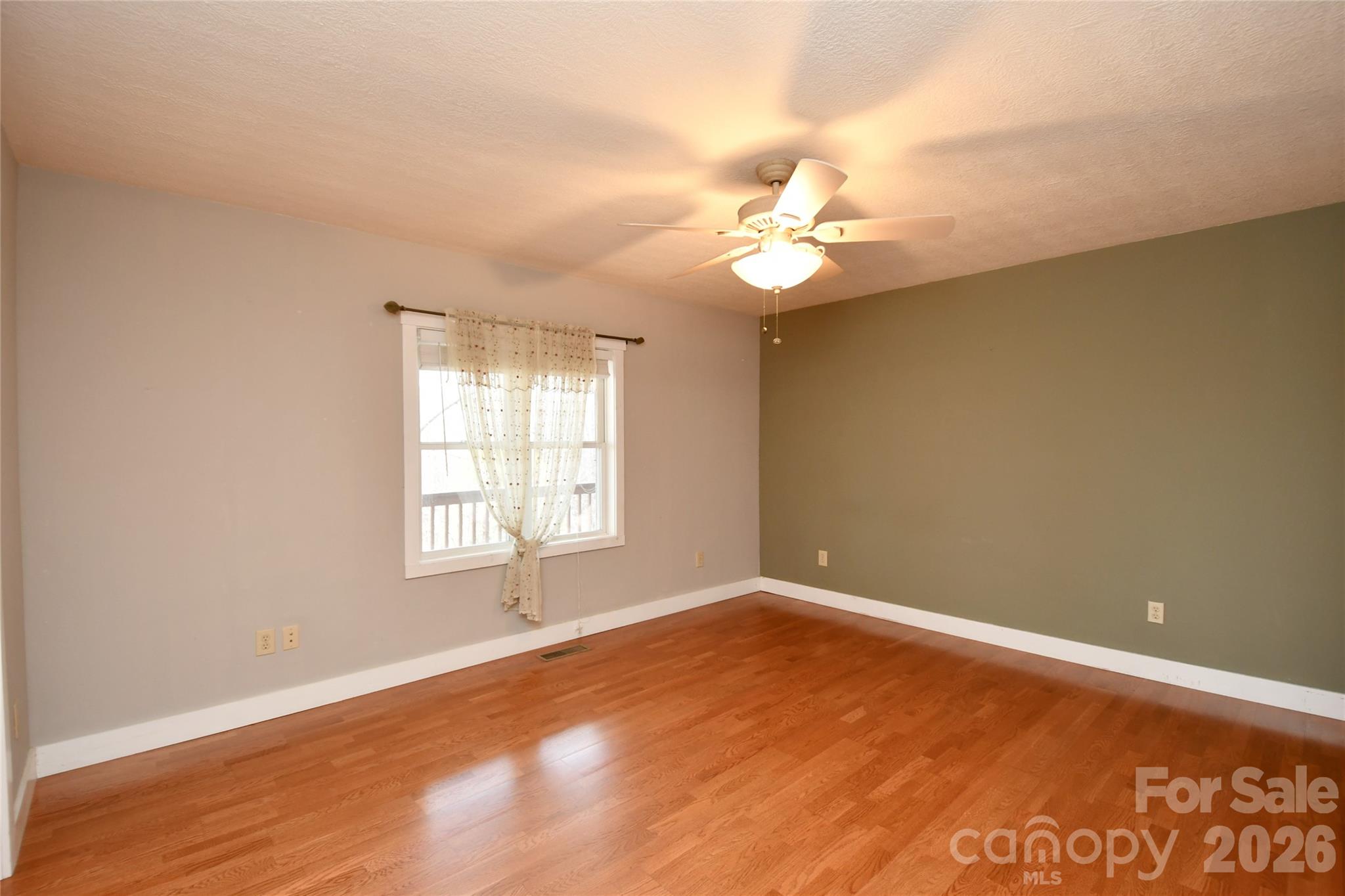 477 West Ridge Drive Burnsville, NC 28714 - Photo 18 of 48 an empty room with a window and ceiling fan