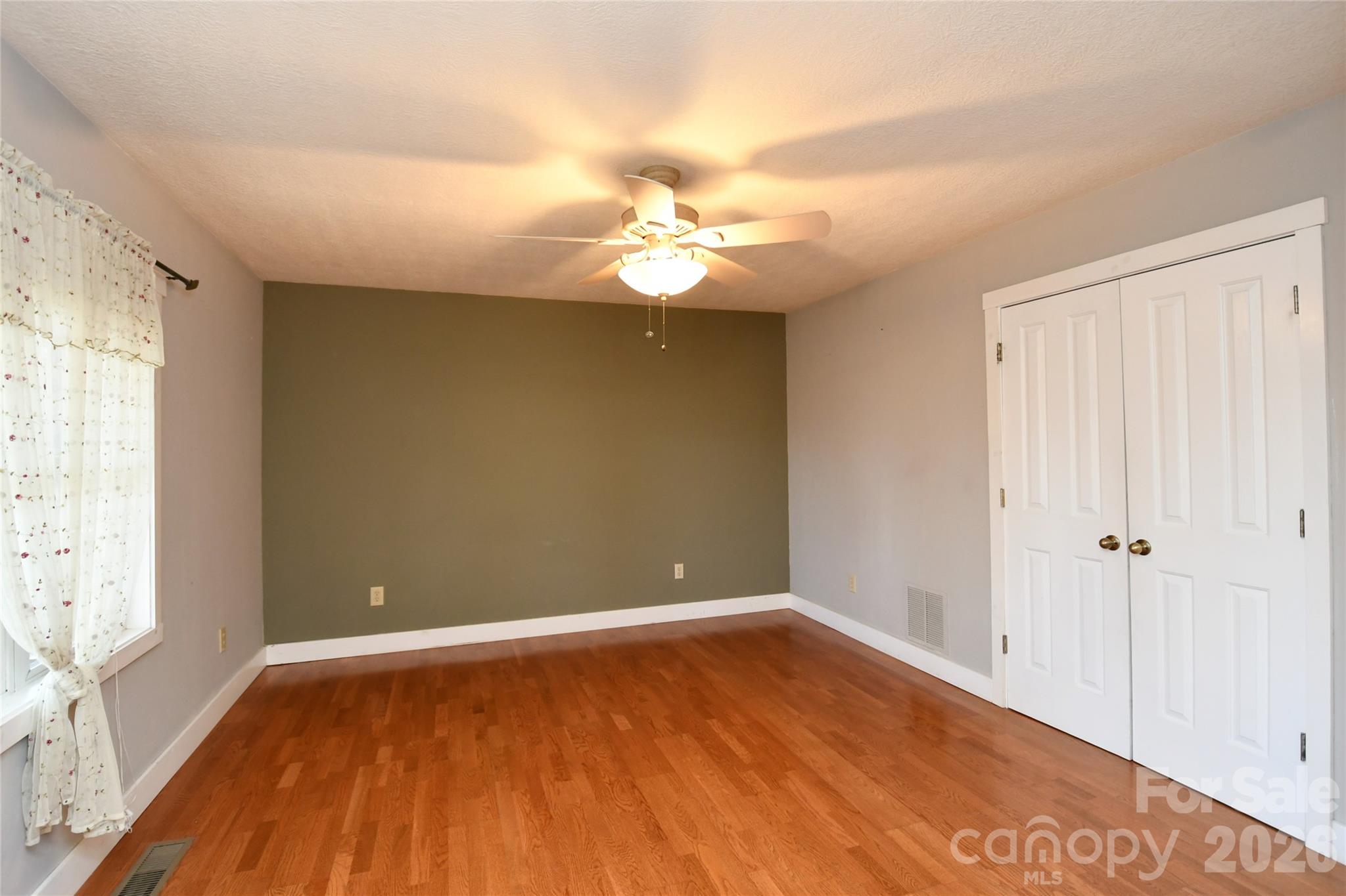 477 West Ridge Drive Burnsville, NC 28714 - Photo 22 of 48 wooden floor in an empty room with a window