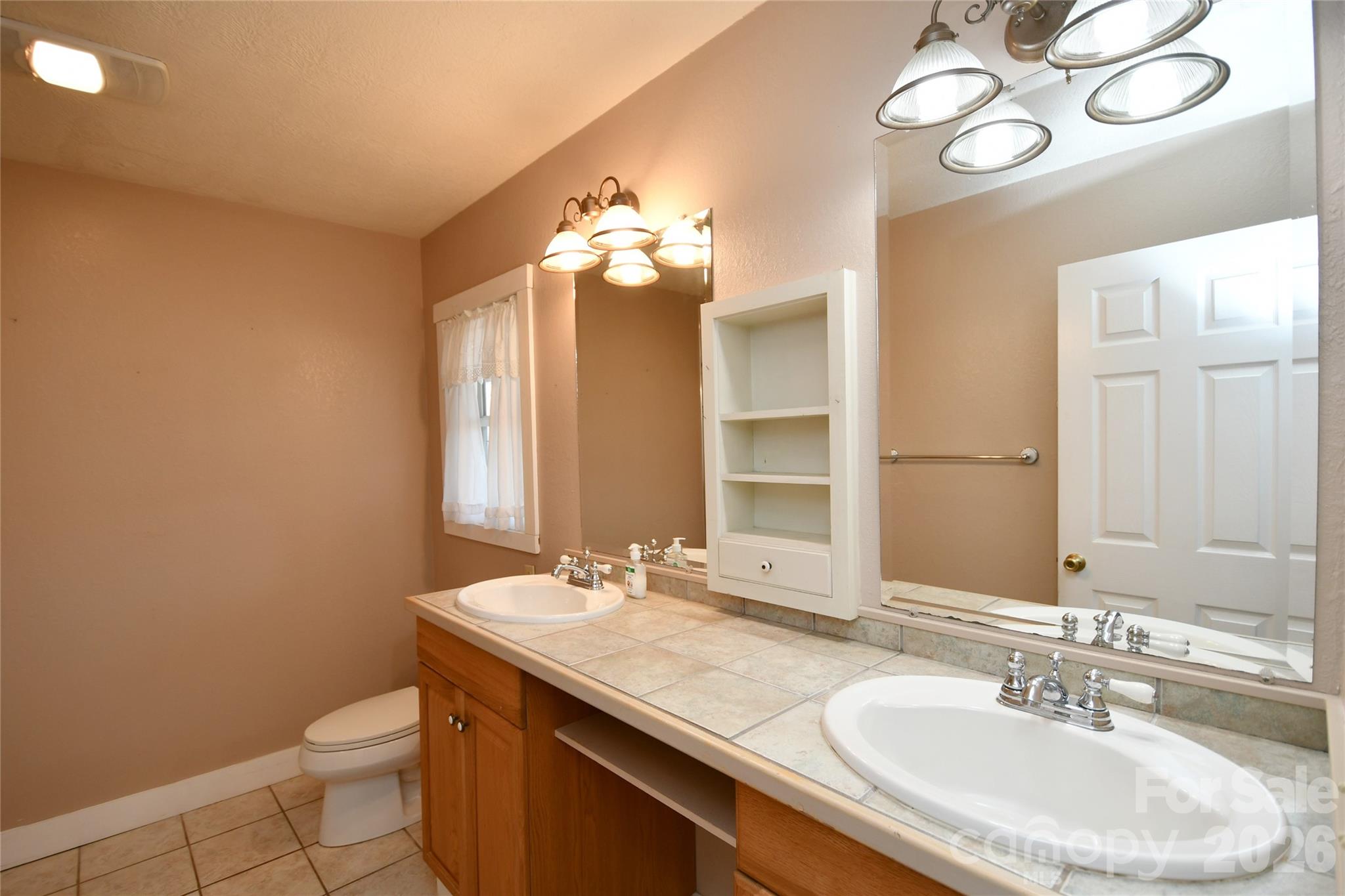 477 West Ridge Drive Burnsville, NC 28714 - Photo 23 of 48 a bathroom with a sink and a mirror