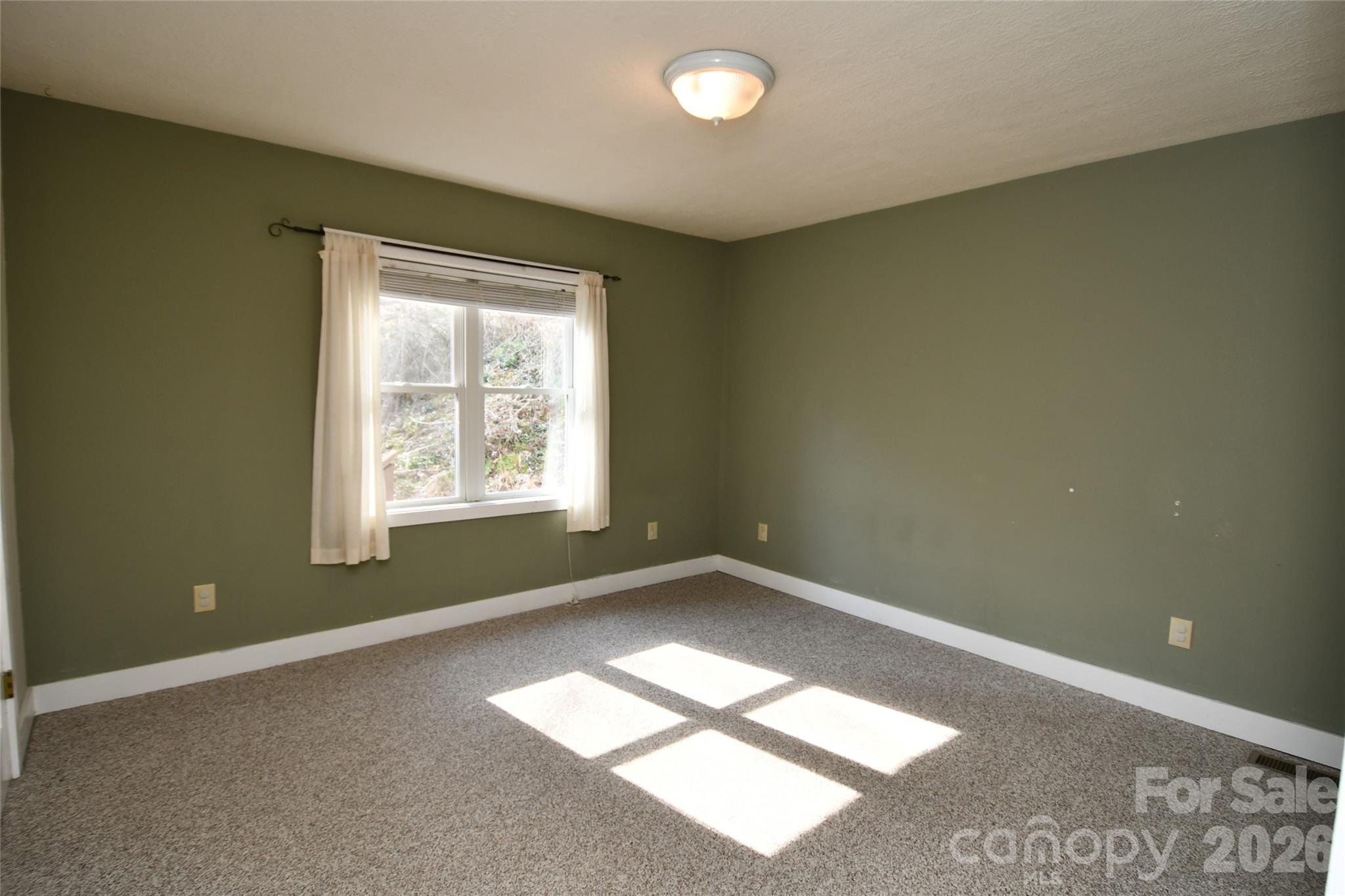 477 West Ridge Drive Burnsville, NC 28714 - Photo 27 of 48 an empty room with a window