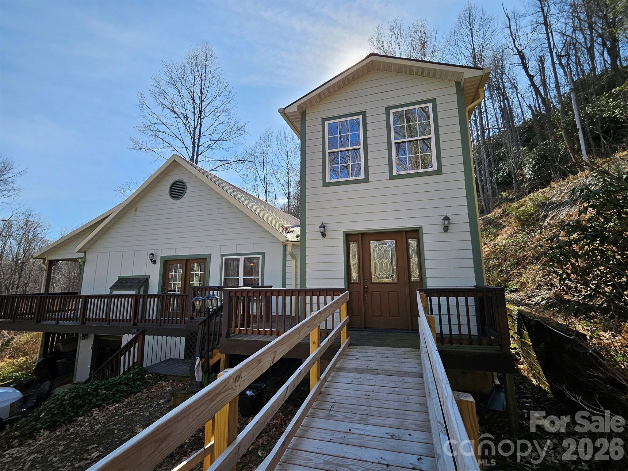 477 West Ridge Drive Burnsville, NC 28714 - Photo 3 of 48 a view of house and wooden deck