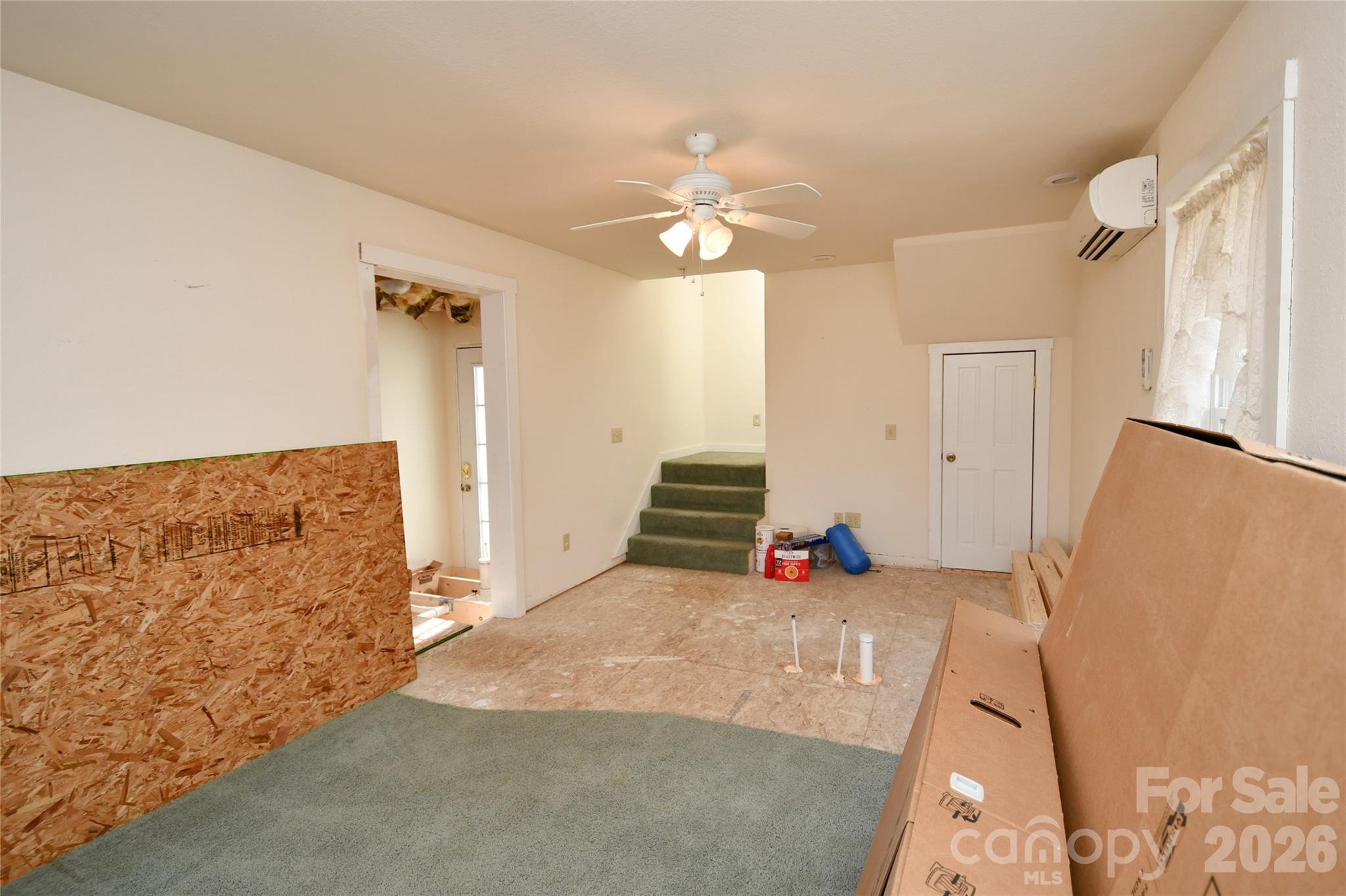 477 West Ridge Drive Burnsville, NC 28714 - Photo 35 of 48 a bedroom with a bed and a chandelier