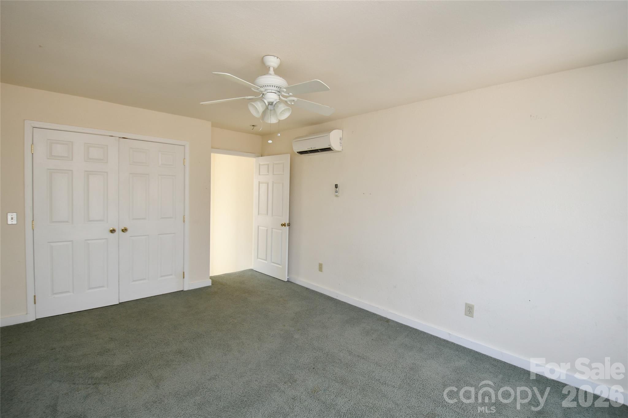477 West Ridge Drive Burnsville, NC 28714 - Photo 38 of 48 an empty room with a ceiling fan and window