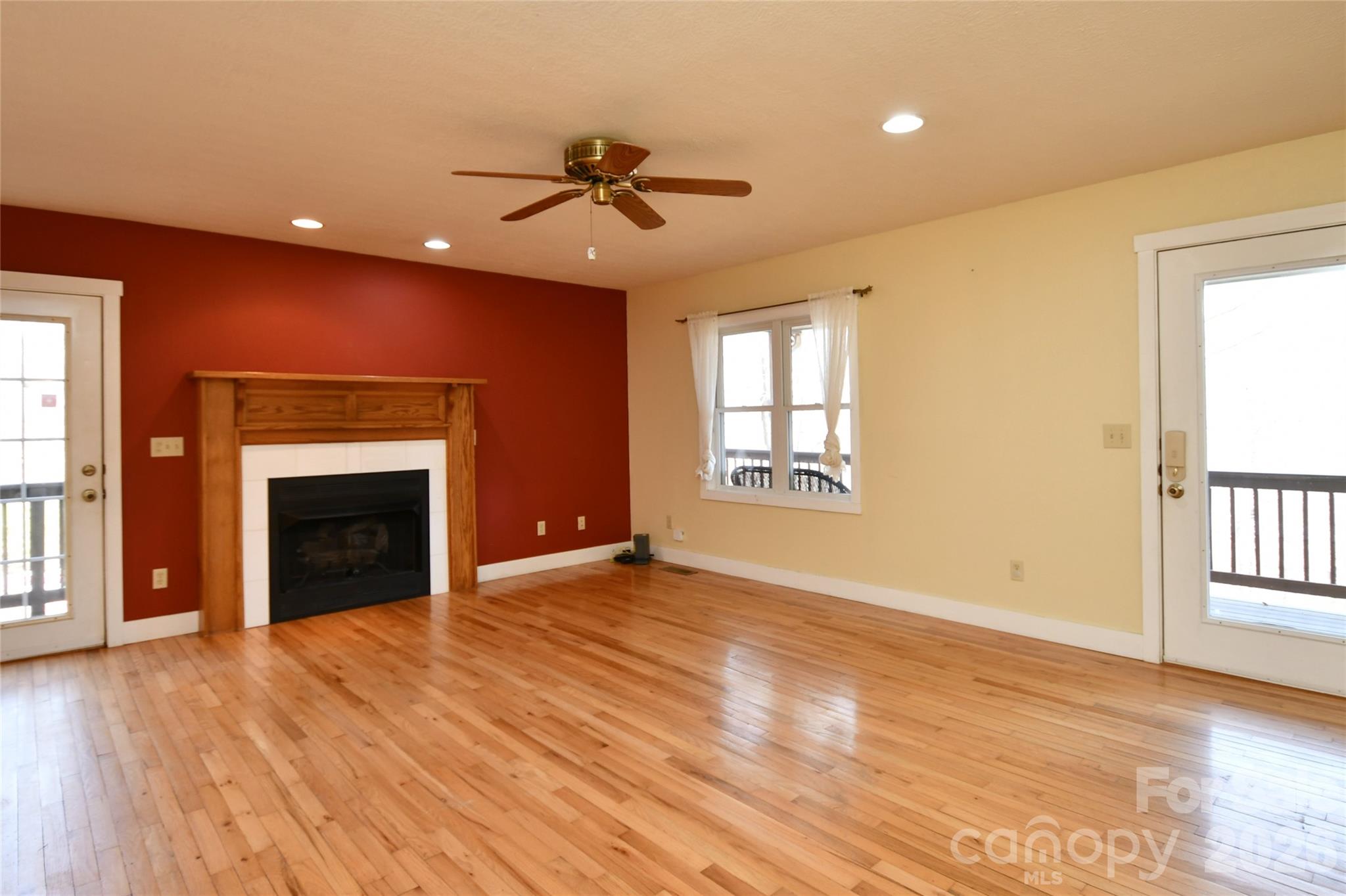 477 West Ridge Drive Burnsville, NC 28714 - Photo 6 of 48 a view of an empty room with a window and fireplace