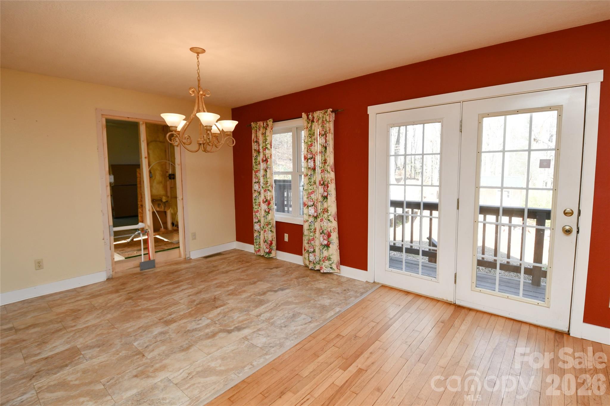 477 West Ridge Drive Burnsville, NC 28714 - Photo 7 of 48 an empty room with wooden floor and windows