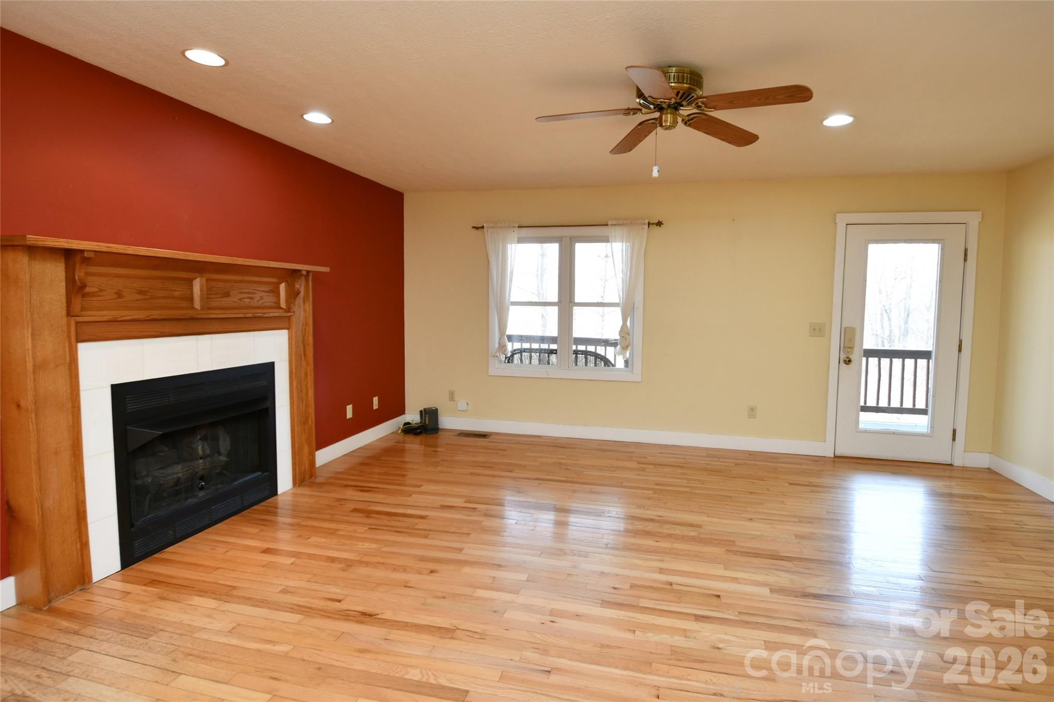 477 West Ridge Drive Burnsville, NC 28714 - Photo 8 of 48 a view of an empty room with a fireplace and a window