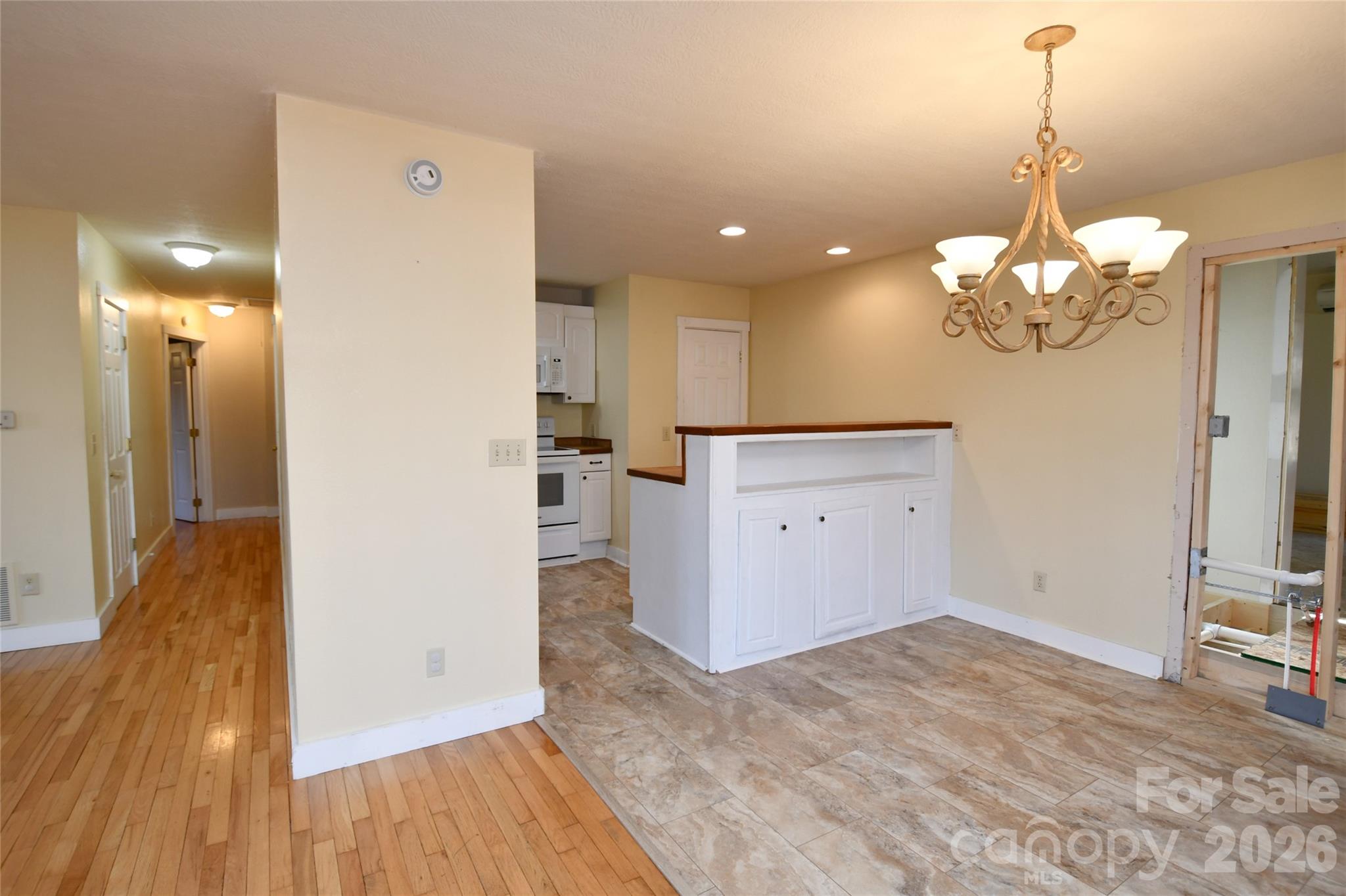 477 West Ridge Drive Burnsville, NC 28714 - Photo 10 of 48 a view of a kitchen with a refrigerator and a wooden floor