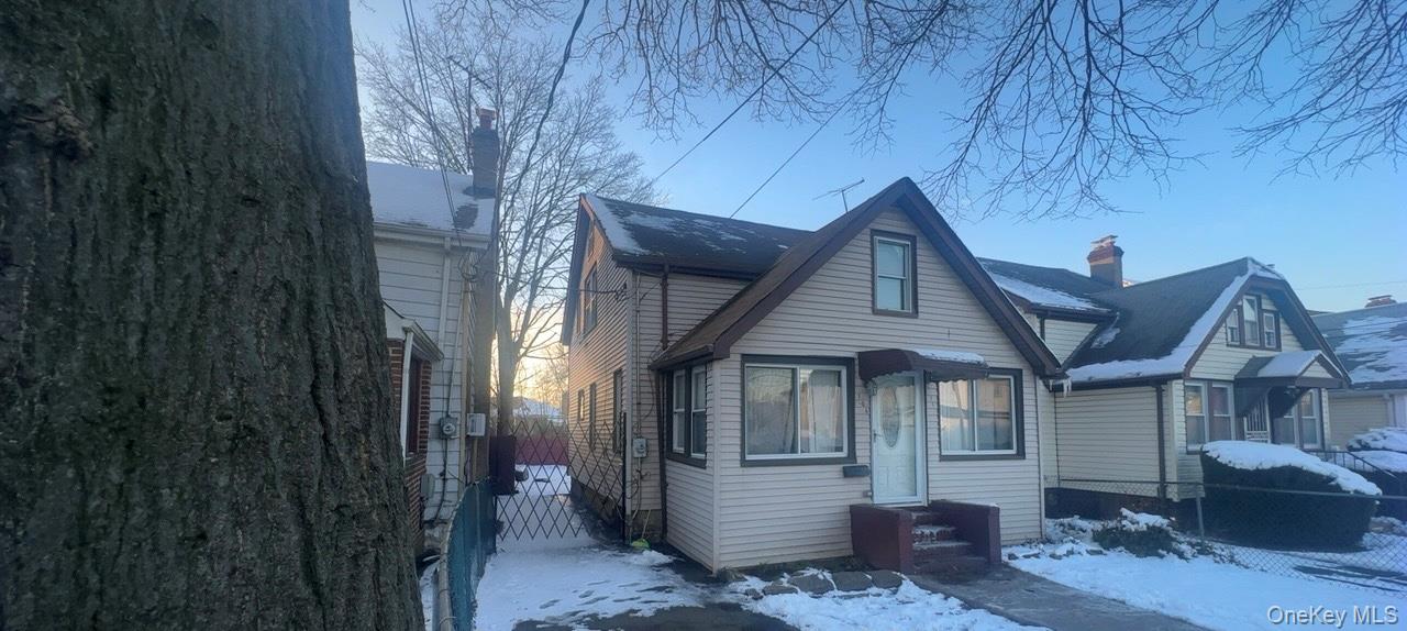 104-14 214th Street Queens, NY 11429 - Photo 3 of 4 View of front facade with a chimney