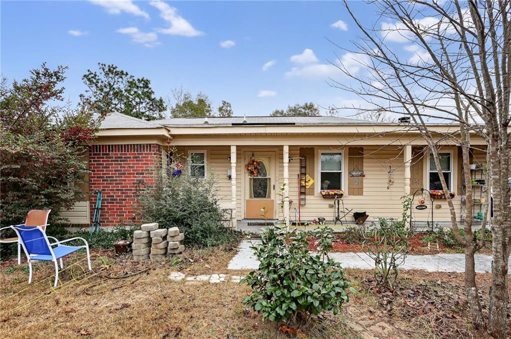 a front view of a house with a garden