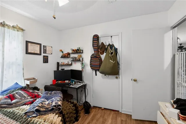 a bedroom with a bed and flat screen tv