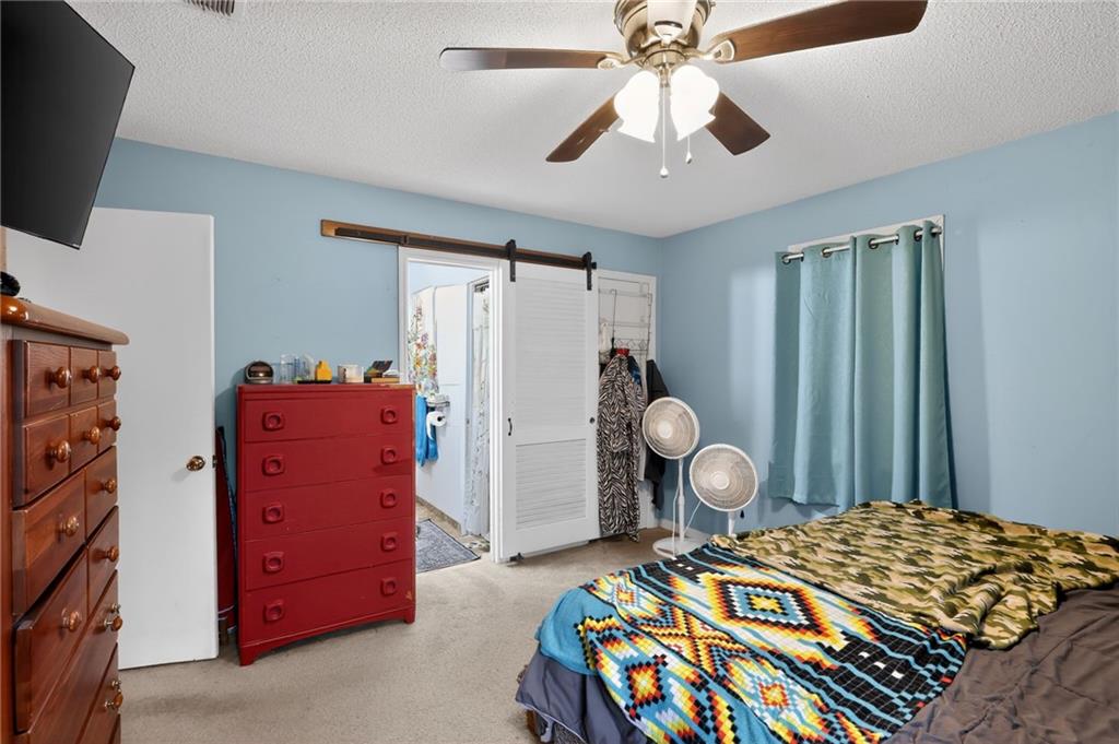 2112 Moncrieff Street Augusta, GA 30906 - Photo 15 of 22 a bedroom with a bed and a chandelier