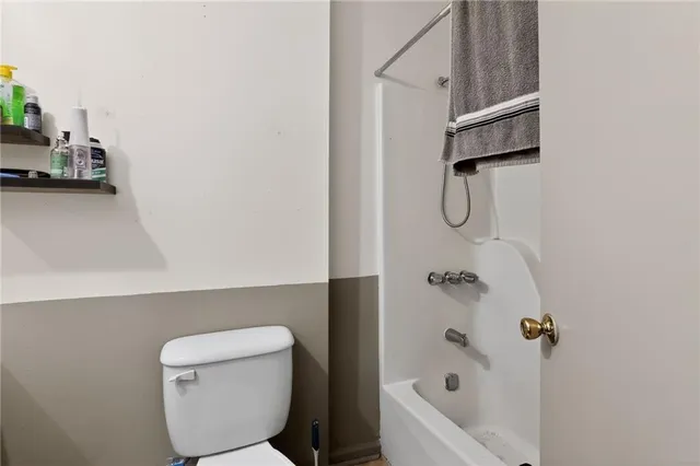a bathroom with a sink toilet and shower curtain