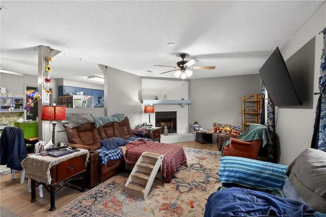 a living room with furniture a flat screen tv and a window