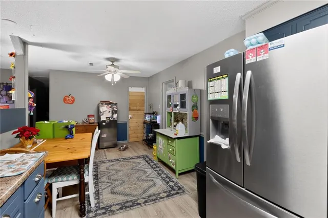 a kitchen with stainless steel appliances granite countertop a refrigerator sink and cabinets