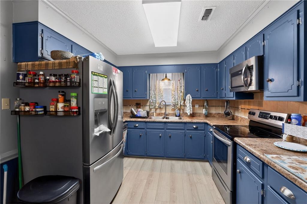 2112 Moncrieff Street Augusta, GA 30906 - Photo 6 of 22 a kitchen with stainless steel appliances granite countertop a refrigerator sink and cabinets