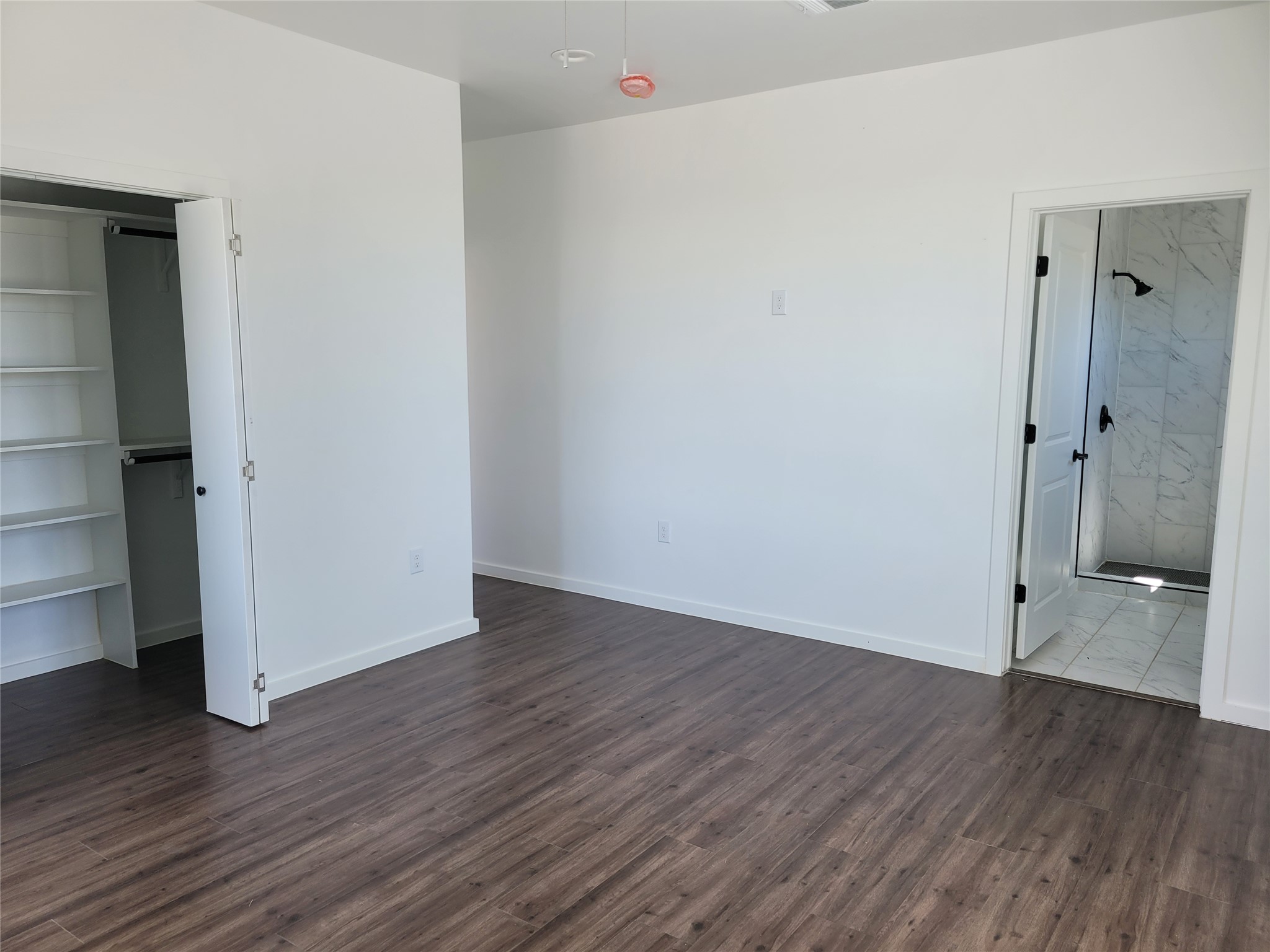 422 A Road Stockdale, TX 78160 - Photo 18 of 40 Ample floor space and rich flooring define this versatile room, featuring an adjoining walk-in closet and a shower bathroom.