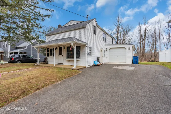 a view of a house with a yard and garage