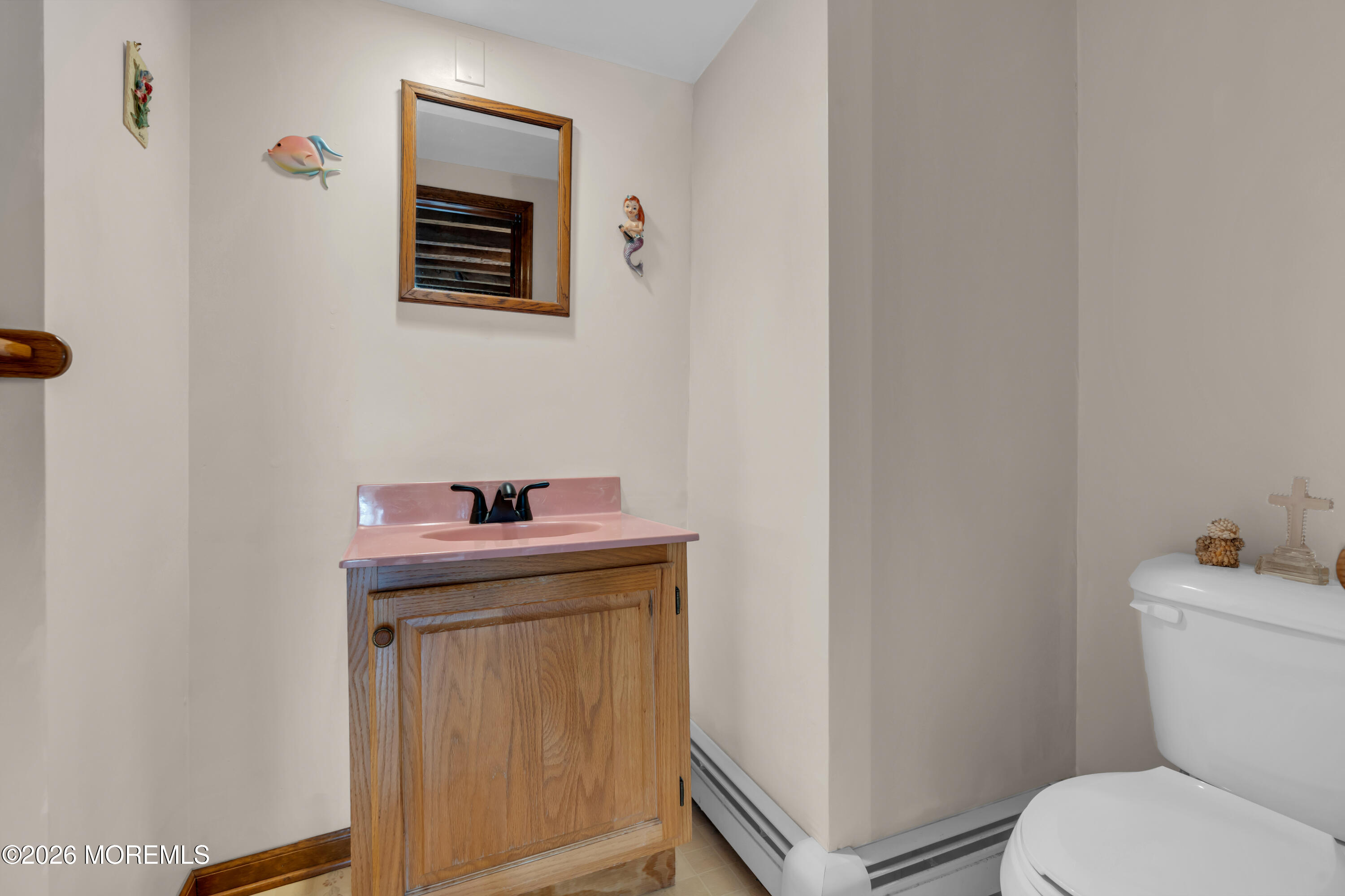 267 Phalanx Road Colts Neck, NJ 07722 - Photo 20 of 36 a bathroom with a toilet a sink and mirror