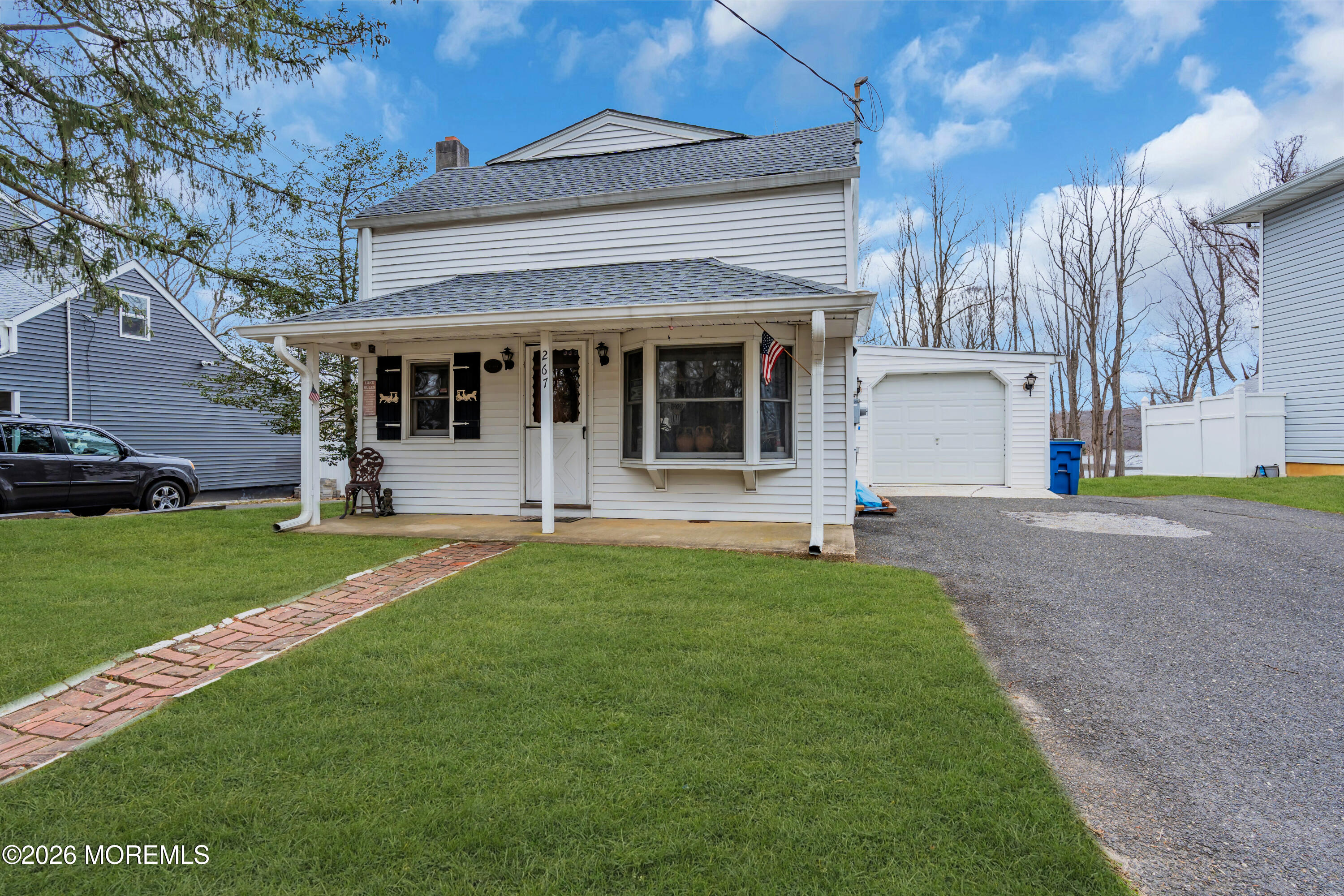 267 Phalanx Road Colts Neck, NJ 07722 - Photo 3 of 36 a front view of a house with a garden and plants