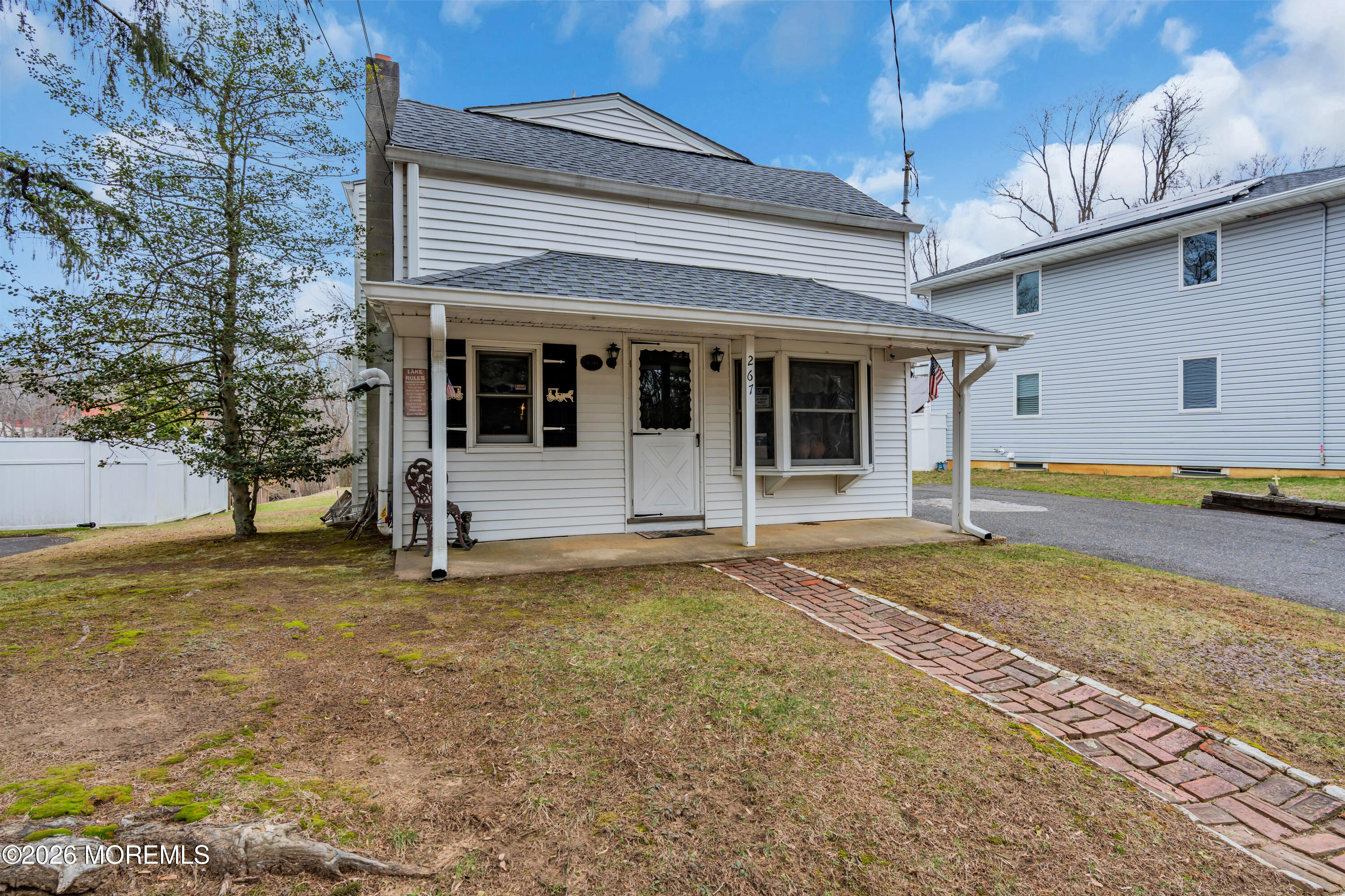 267 Phalanx Road Colts Neck, NJ 07722 - Photo 32 of 36 a view of a house with a backyard and a tree