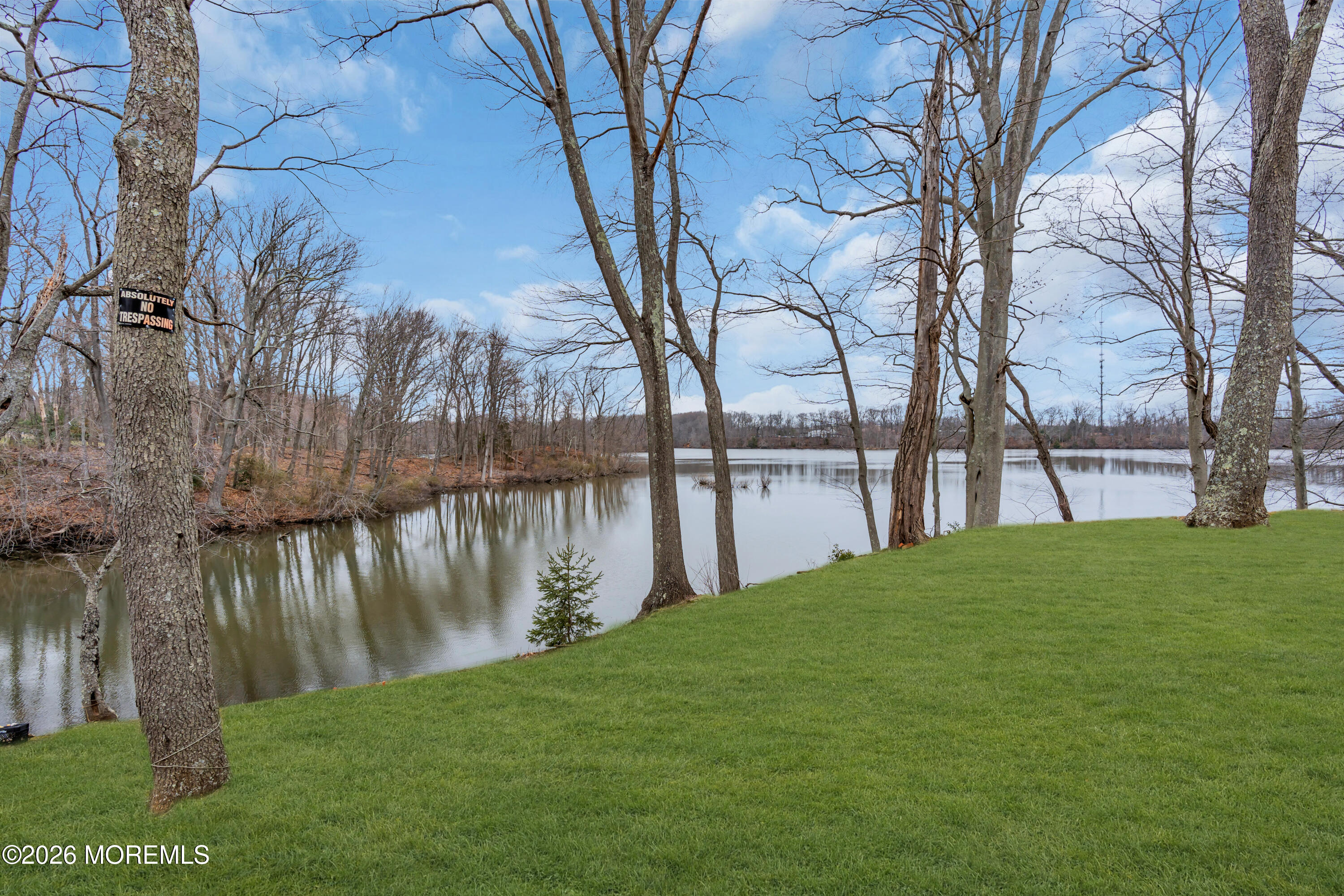 267 Phalanx Road Colts Neck, NJ 07722 - Photo 8 of 36 a backyard of a house with lots of green space and lake view
