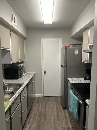 a kitchen with a refrigerator and a sink