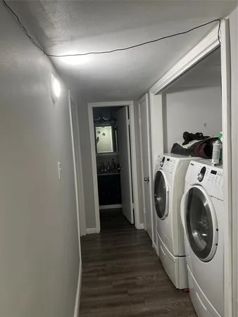 a view of a hallway with washer and dryer